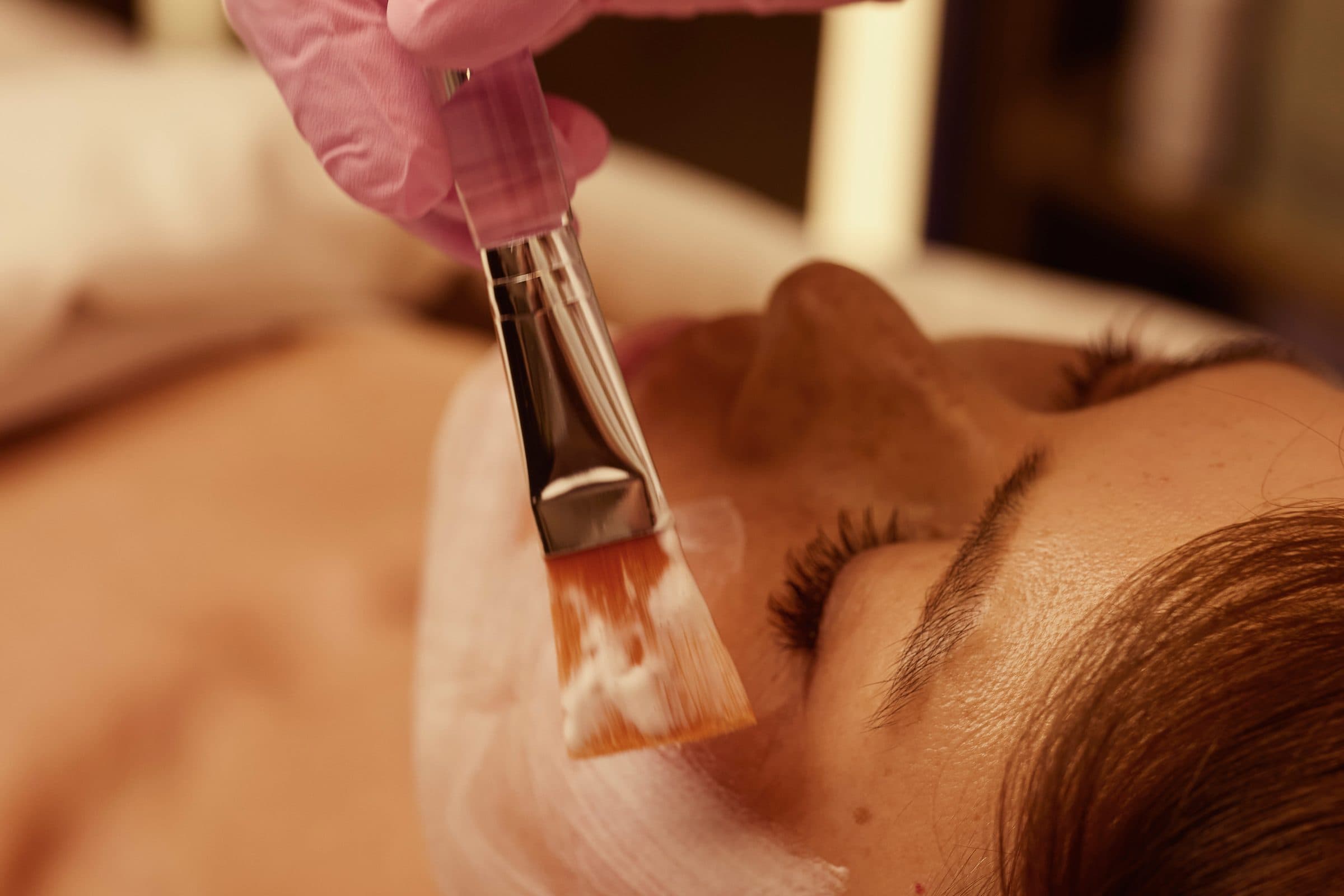 Zhanna Graeff applying a masque with a brush